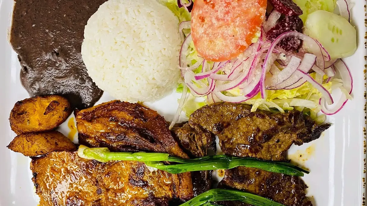 Grilled steak with sweet plantains, rice, beans and salad