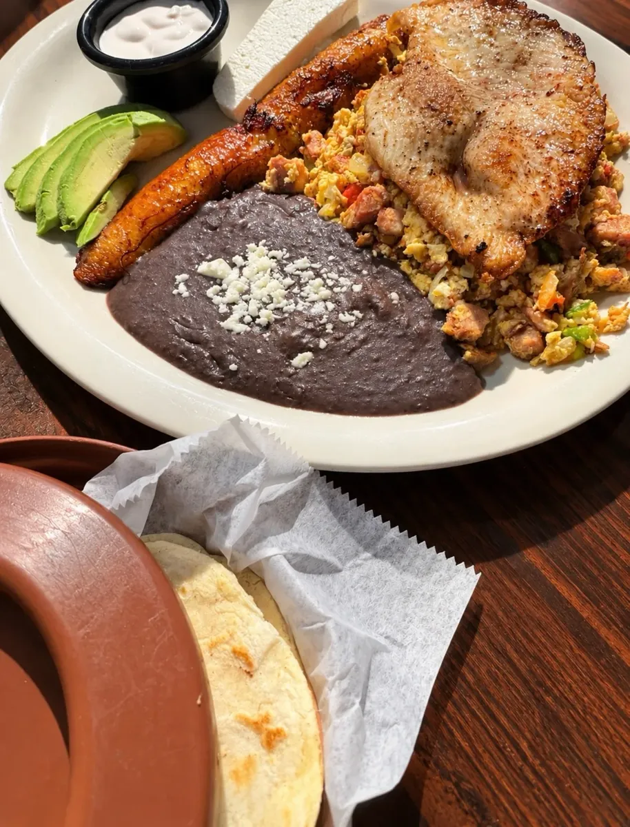 Breakfast plate with sweet plantains, black beans and avocado
