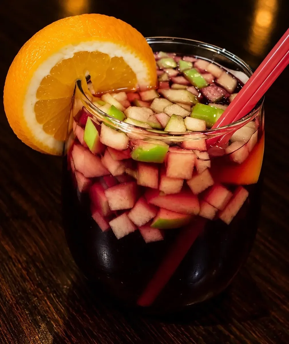 Sangria full of fruit with an orange slice