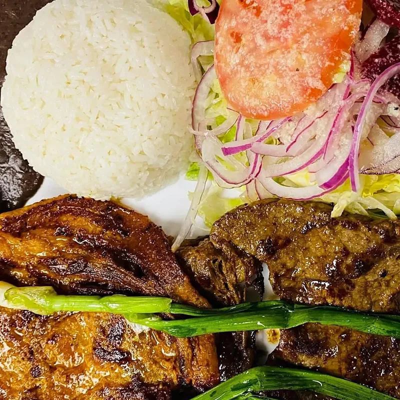 Grilled steak with sweet plantains, rice, beans and salad