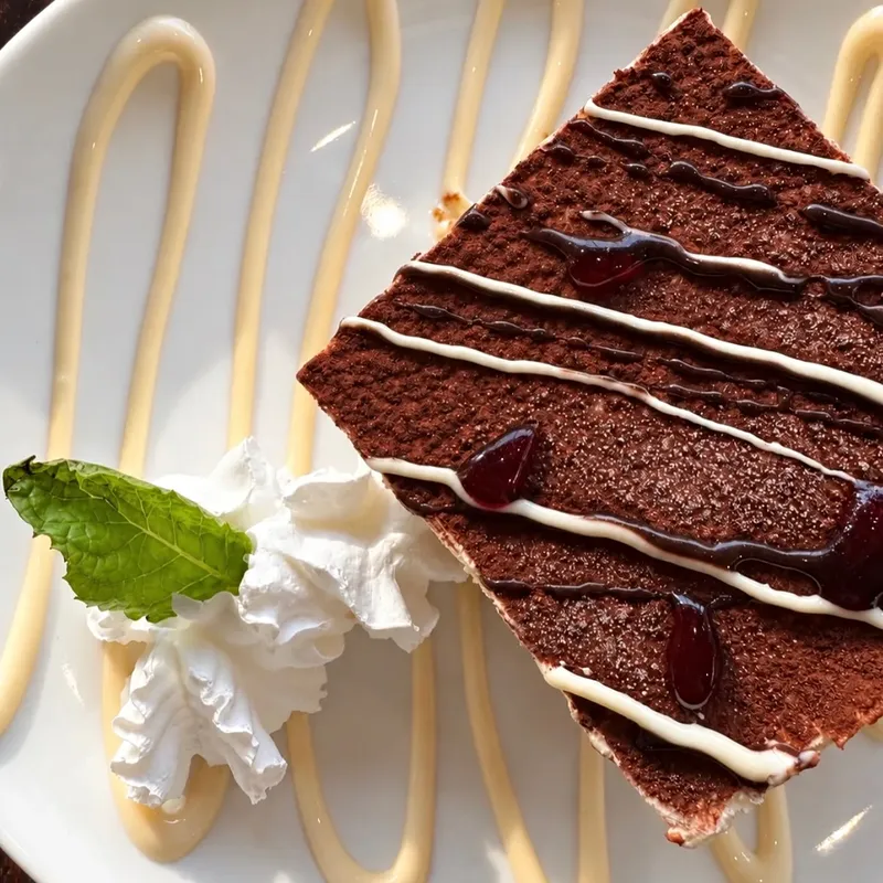 Tiramisu with whipped cream and mint
