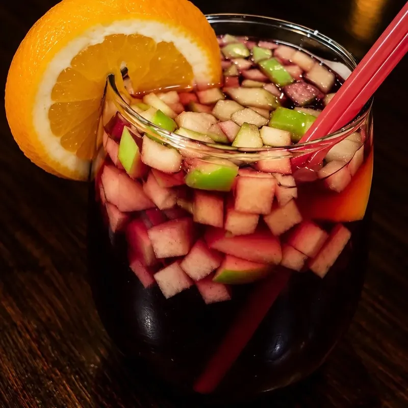 Sangria full of fruit with an orange slice